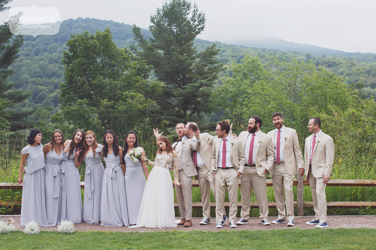 Funny photo of the wedding party in tweed suits and lilac dresses at this rustic Stowe, VT wedding.