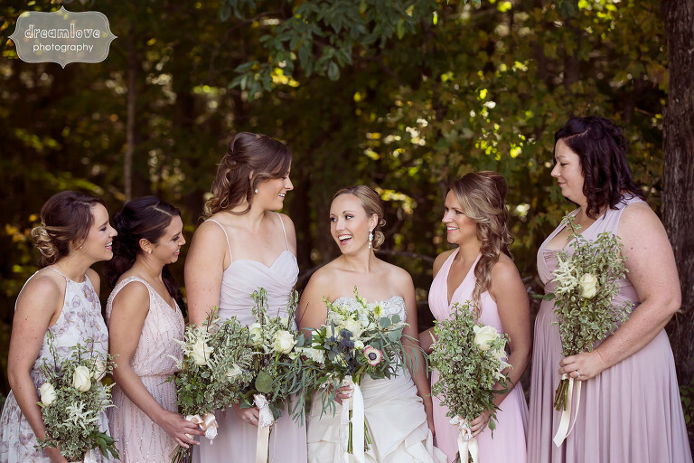 Bridesmaids laughing in the woods at the Warfield House Inn.
