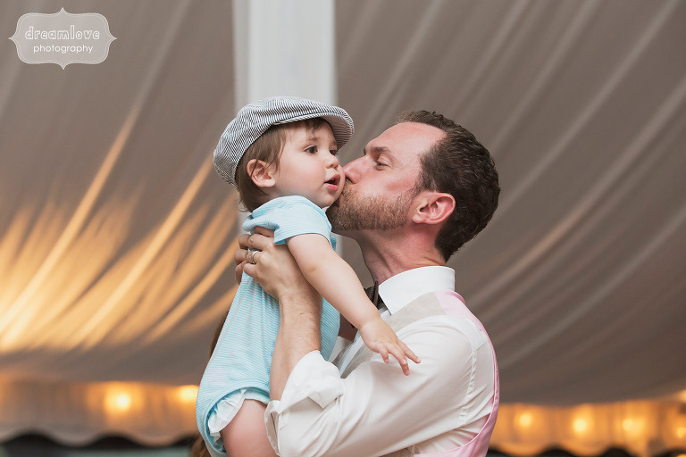 The groom kisses a toddler wedding guest at the Topnotch Resort in Stowe, VT.