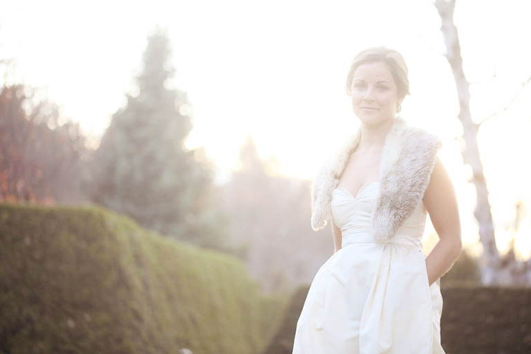 Beautiful backlit photo of a bride during her winter wedding at the Woodstock Inn. 