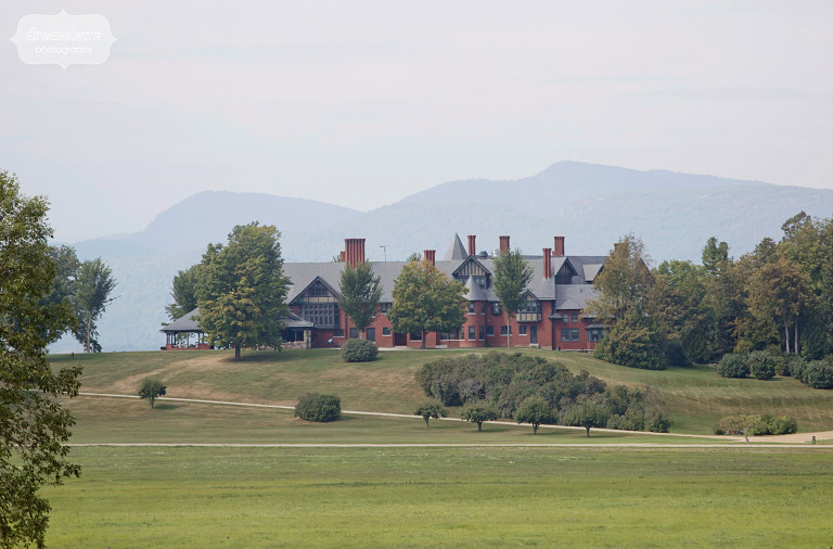 view of the shelburne farms wedding estate venue with mountains behind it