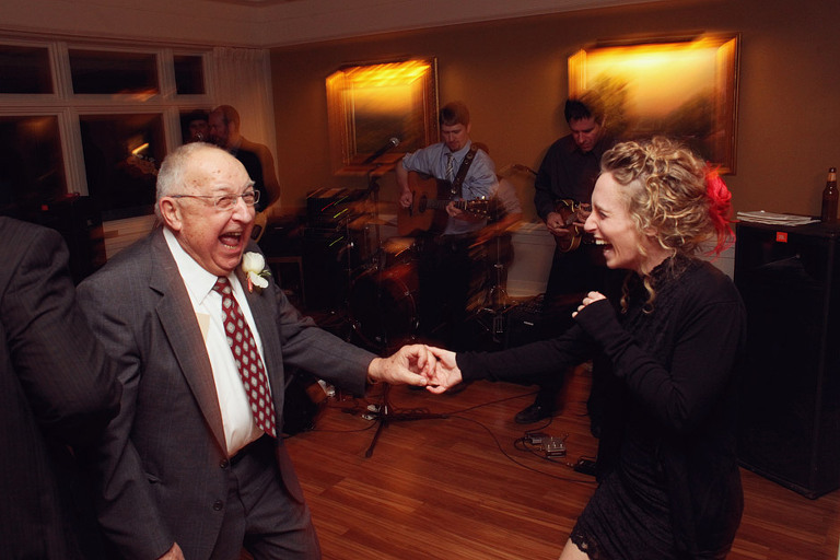 Older couple dances during a wedding reception. 