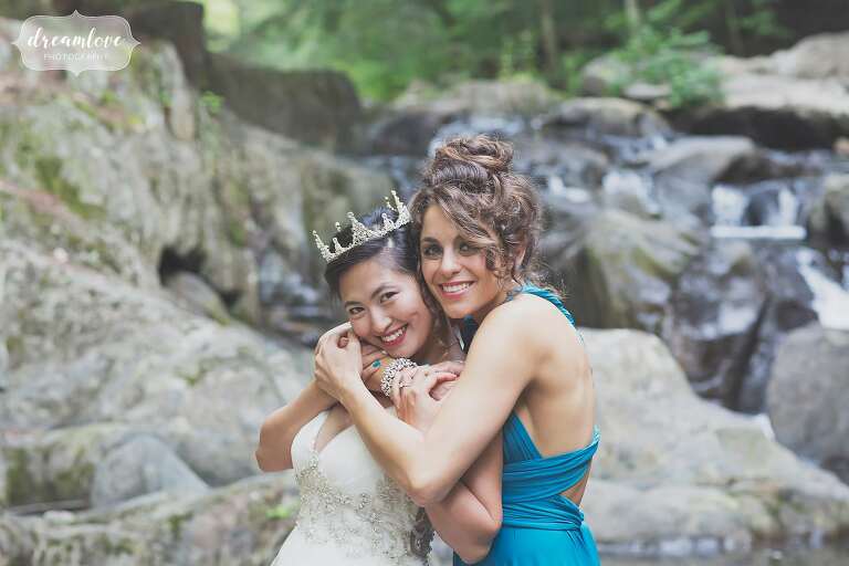 Bride and her best friend by the creek for this backyard wedding.