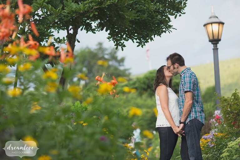 Couple kissing during their Shelburne Falls engagement photo session on the Bridge of Flowers.