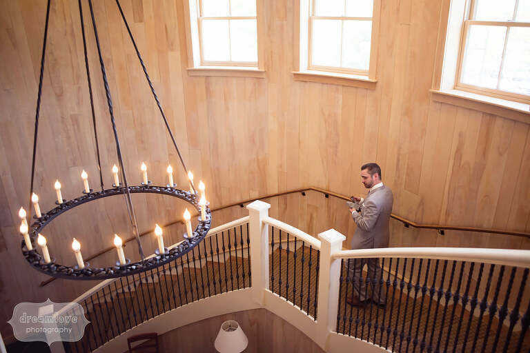Groom walks down the staircase at the Sugarbush Resort in VT.