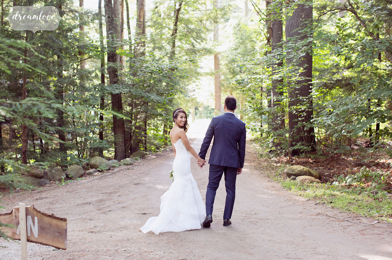 Natural and woodsy wedding portraits of the bride and groom in the forest in Wolfeboro.