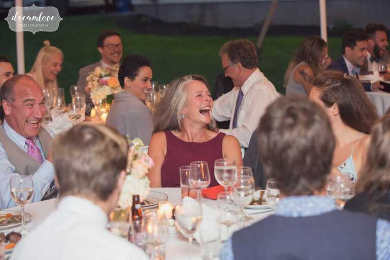 The family laughs during speeches at a north shore wedding.