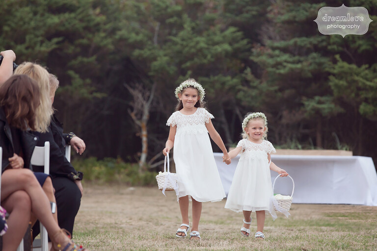 Adorable flower girls hold hands for Cape Cod wedding.