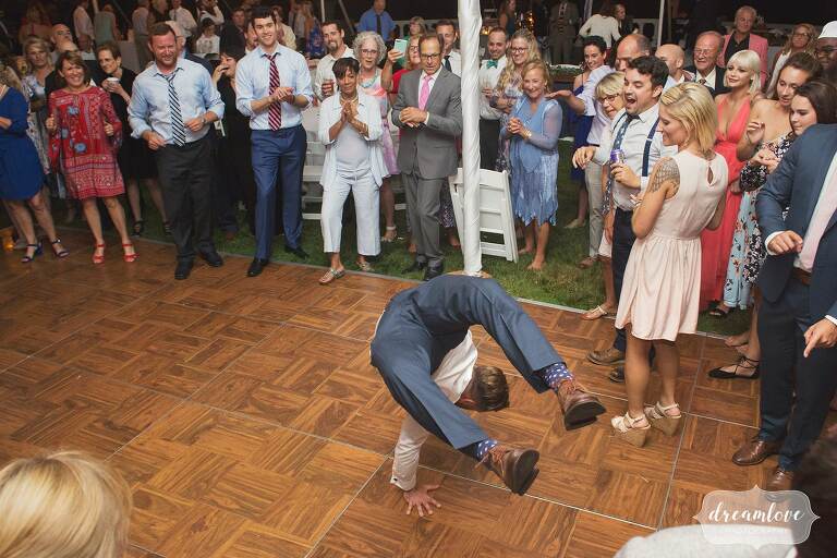 The groom does a back flip on the dance floor at Manchester by the Sea, MA.