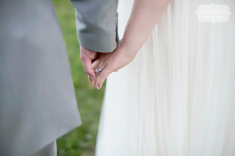 Bride and groom hold hands during their June wedding at Sugarbush in VT.