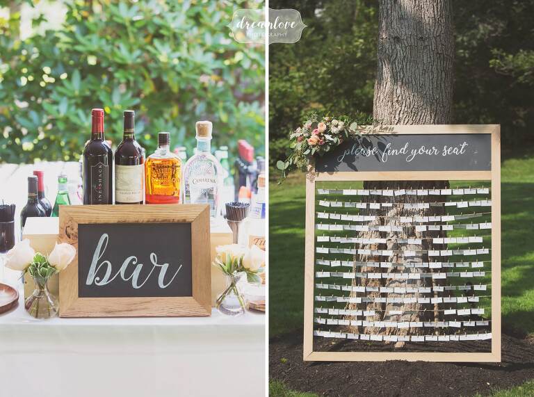 Rustic escort card set up in old picture frame with small clothespins.