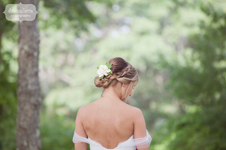 Beautiful bride with freesia flower in her hair with braid on Cape Cod.