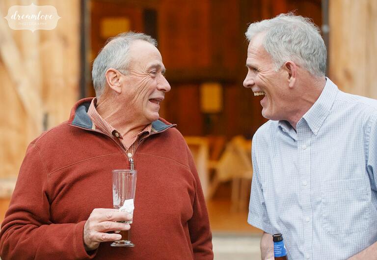 Great documentary photo of two older men laughing at Gould Barn.