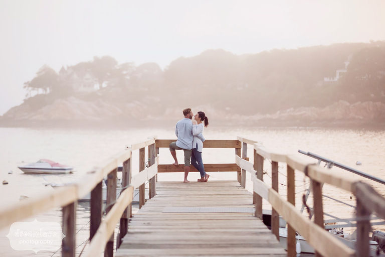 Rustic engagement photography of couple at the end of the pier at the Singing Beach in MA.
