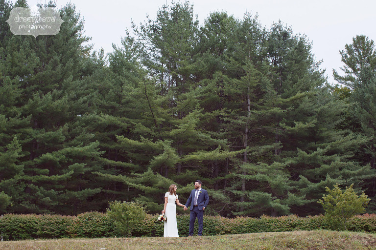 Bride and groom with the forest behind them at this Quechee, VT farm wedding.