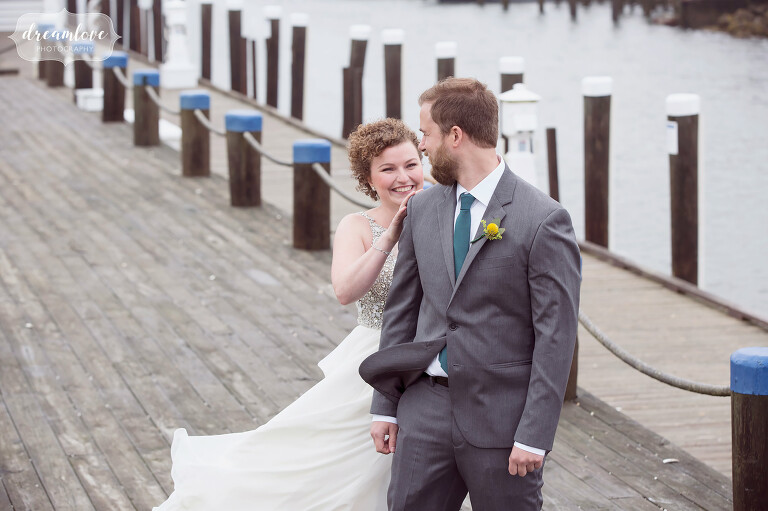The bride taps the groom on the shoulder during their first look at this natural Wychmere wedding on Cape Cod.