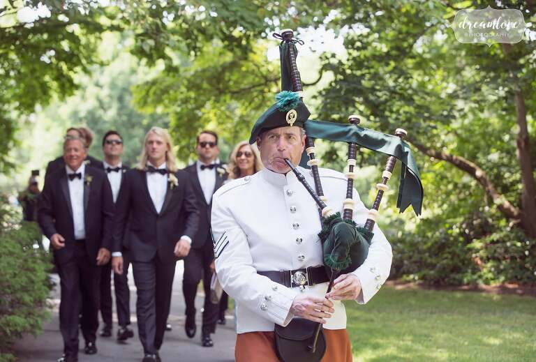 A bagpiper leads the groom and his groomsmen to the chapel on Bucknell campus in PA.
