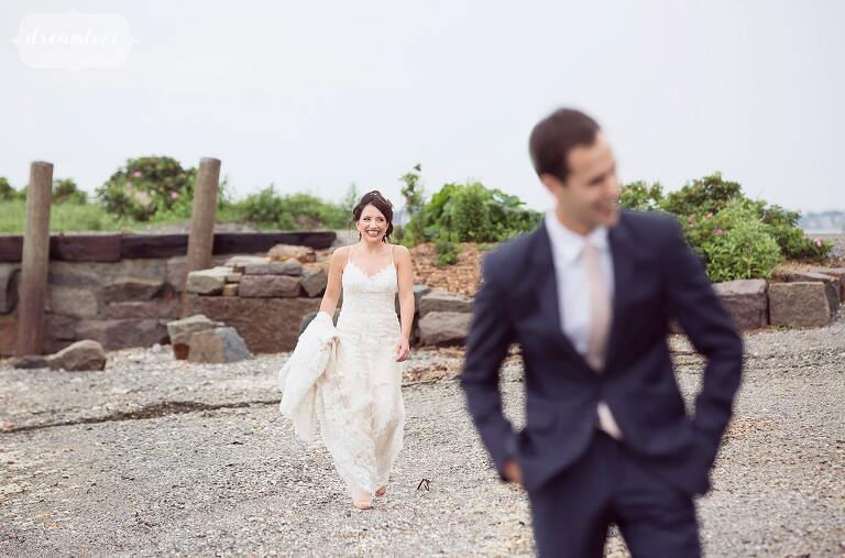 The bride and groom have their first look on the beach at this Boston Harbor wedding on Thompson Island.