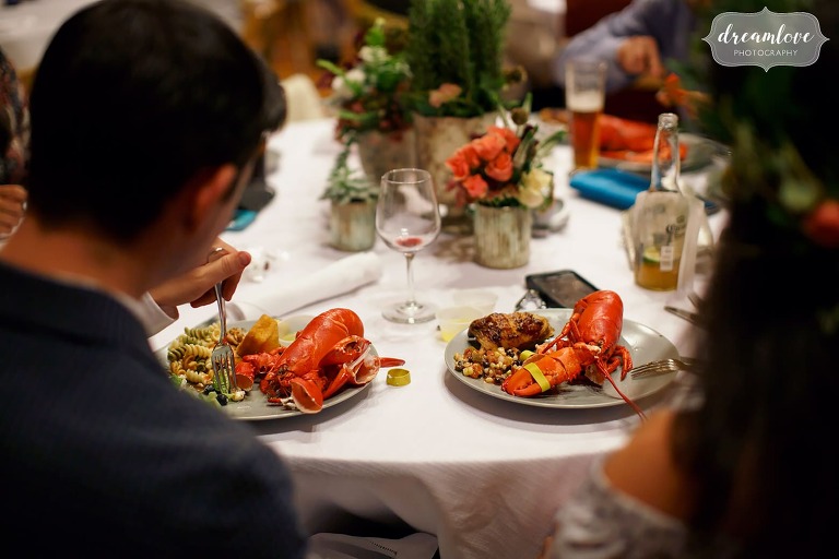 Guests at this Gould Barn rehearsal dinner enjoy steamed lobsters with their clambake dinner.