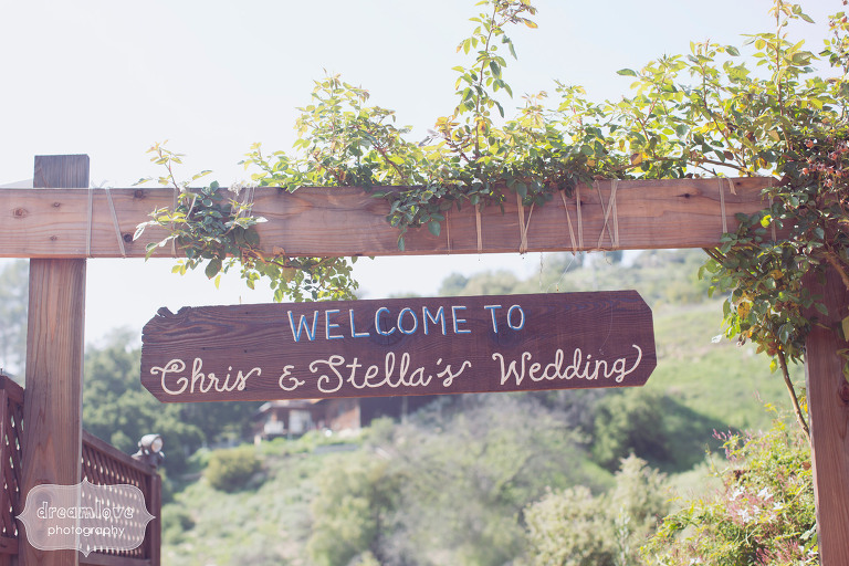 Handmade wooden wedding sign at the 1909 that says, "Welcome to Chris and Stella's Wedding"