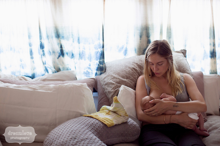 Breastfeeding mom nurses newborn baby in bed in Venice, CA.