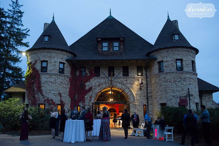 Guests enjoy the cocktail hour and arcade games at Larz Anderson chateau.