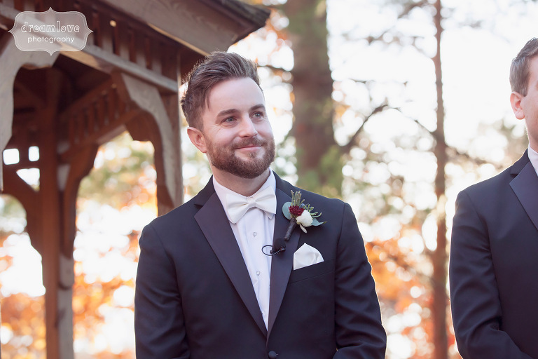 Groom watches the bride walk down the aisle at this rustic outdoor wedding ceremony in CT.