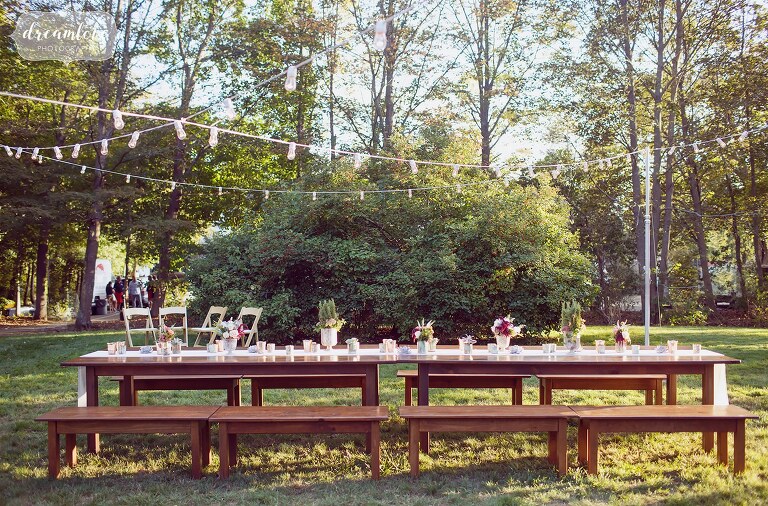 Romantic family style dinner table set up outside of Gould Barn for the rehearsal dinner.