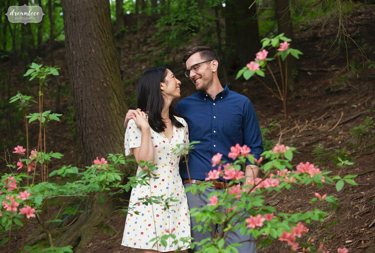 Couple stands in woodsy location at the Arnold Arboretum at Harvard University.