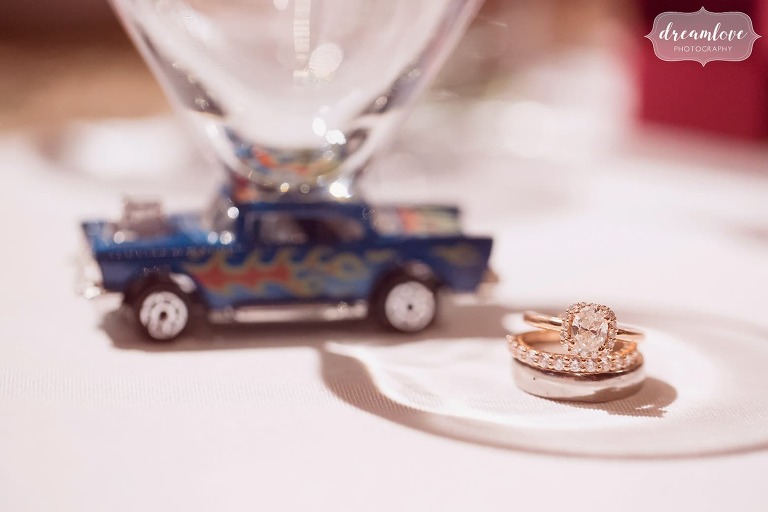The wedding rings are pictured at this antique car themed wedding at Larz Anderson.
