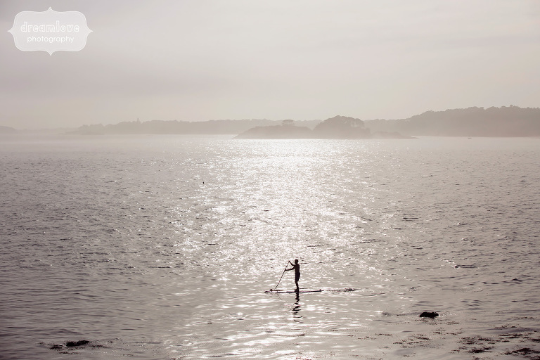 Foggy ocean landscape with SUP boarder during engagement shoot.