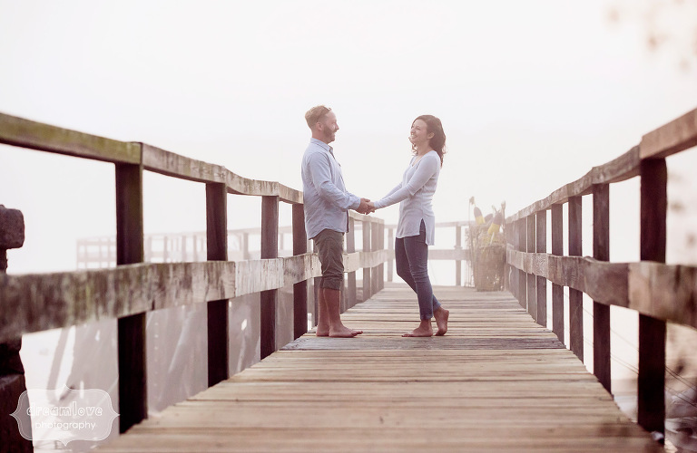 Candid wedding photo of couple holding hands on the pier in Manchester-by-the-Sea.