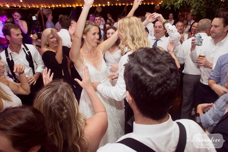 The bride throws her arms in the air at the end of this One Barn Farm wedding.