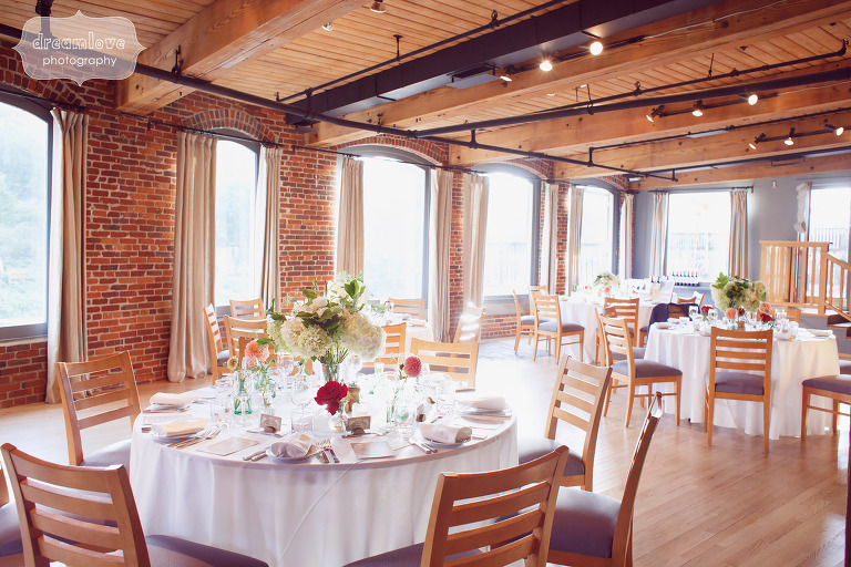 Vermont wedding reception with Anthropologie details and flowers at Simon Pearce Glass Factory.