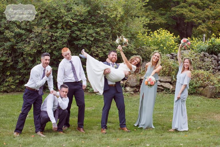 Silly photo of wedding party with groom picking up bride at Curtis Hollow Farm.