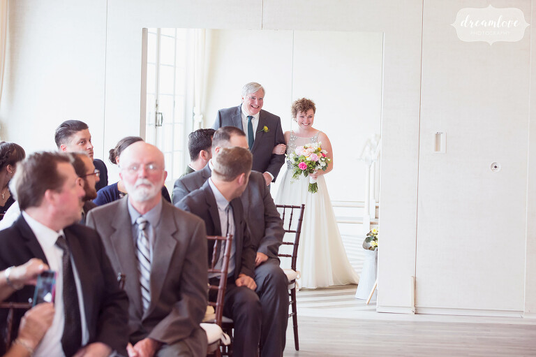 Bride and her father walk down the aisle during the indoor ceremony at the Wychmere.
