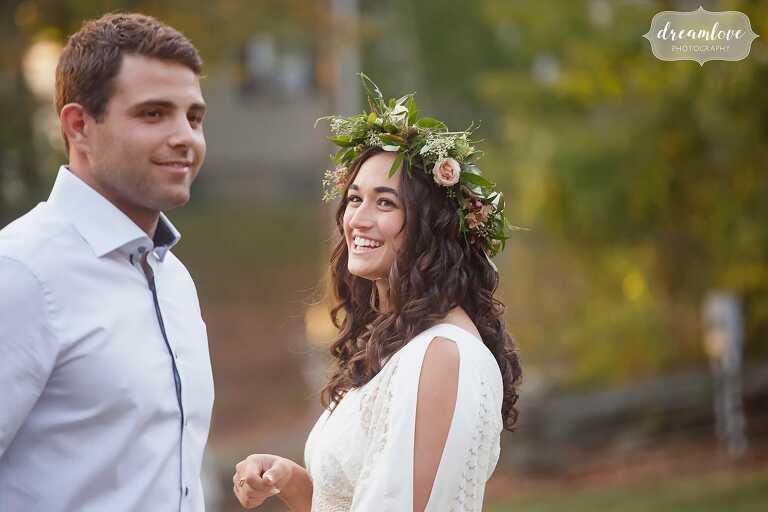 Candid photo of the bride to be smiling in her flower crown at this Gould Barn rehearsal dinner.