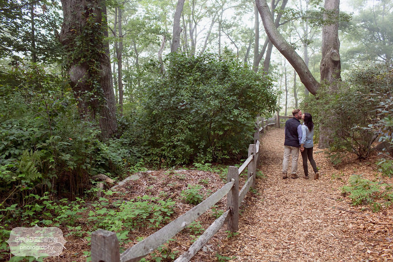 Couple walking along path during a autumn engagement session in MA.