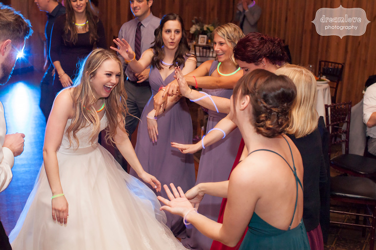 Bride laughing while dancing with her bridesmaids at this Crystal Lake Pavilion wedding.