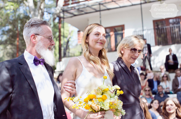 The bride is accompanied by her parents down the aisle at the 1909 in Topanga, CA.