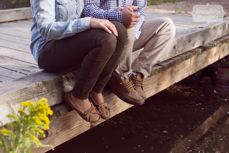 Rustic engagement photography of couple along a bridge in MA.