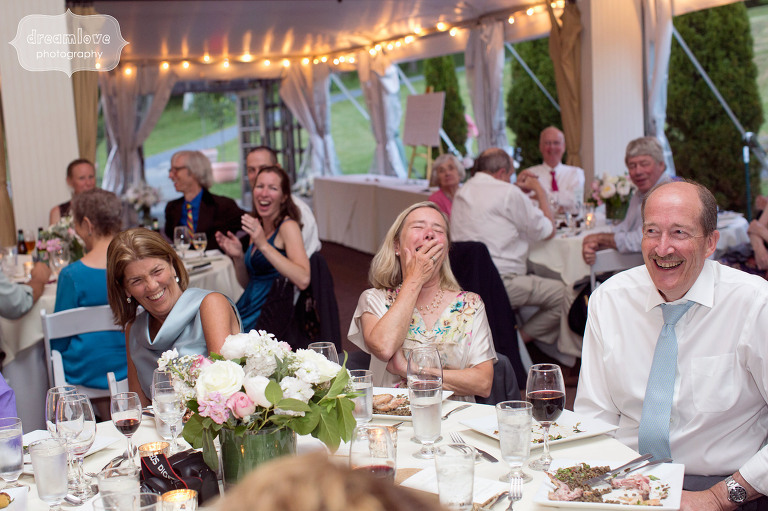 Guests laughing during wedding speeches in the tent at the Hildene in Manchester, VT.