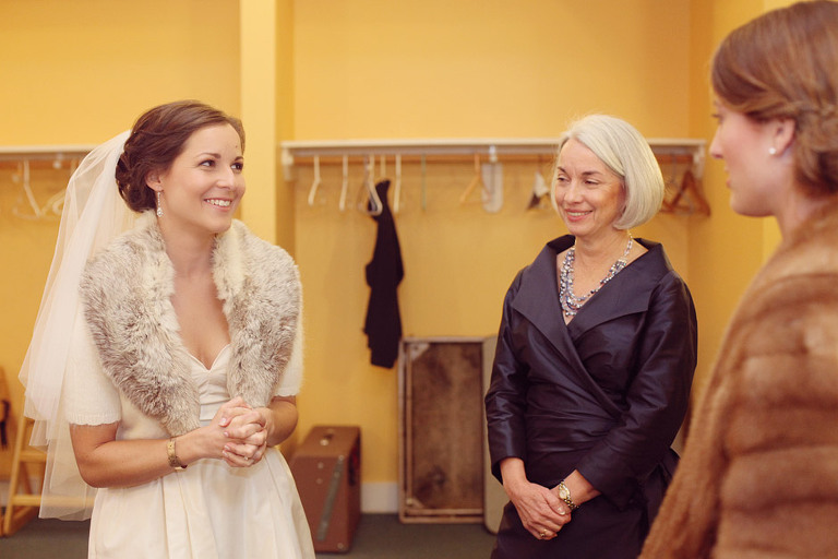 A bride laughs with her mother before getting married. 