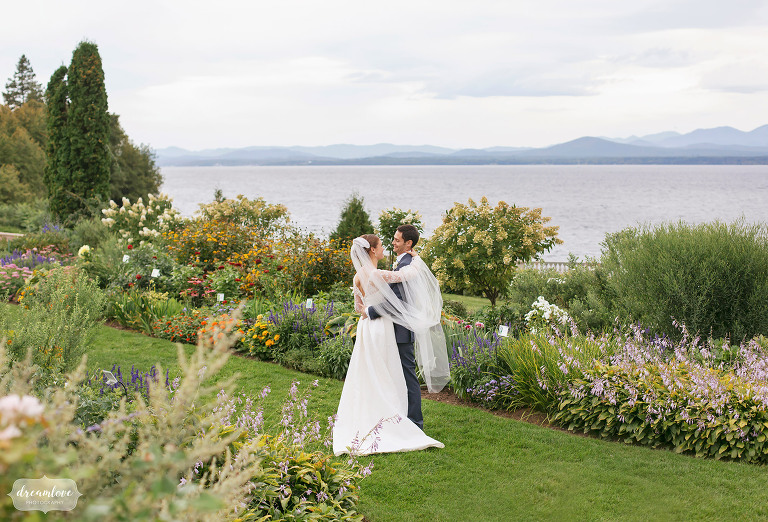 Bride and groom kiss in the garden before their Shelburne Farms VT wedding.