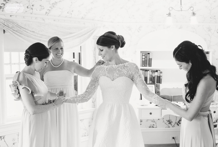 Bride is helped by bridesmaids at the Shelburne Farms Inn.
