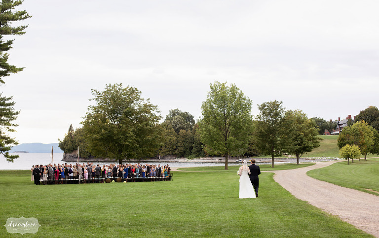 Bride walks into outdoor wedding ceremony at Shelburne Farms, VT.