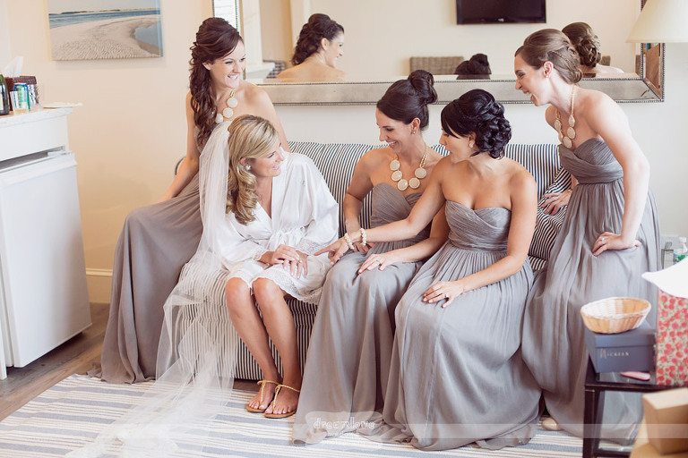 Bridesmaids laugh while getting ready for a wedding at the Wychmere Beach Club. 