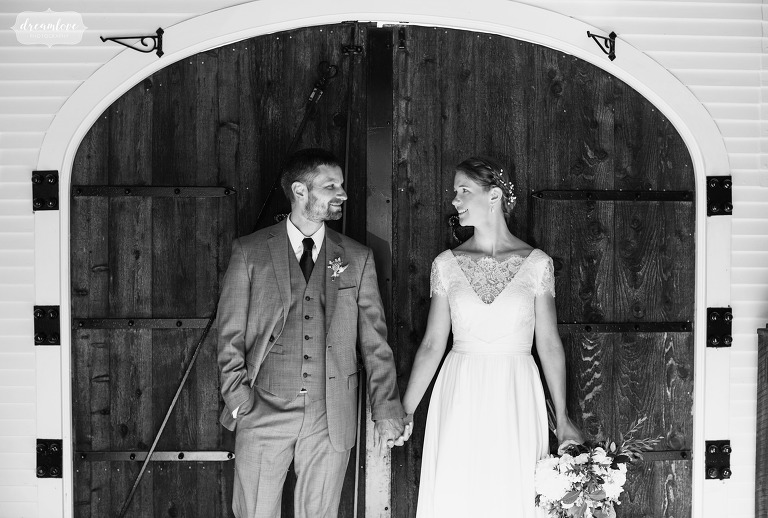 Black and white photo of bride and groom looking at each other.