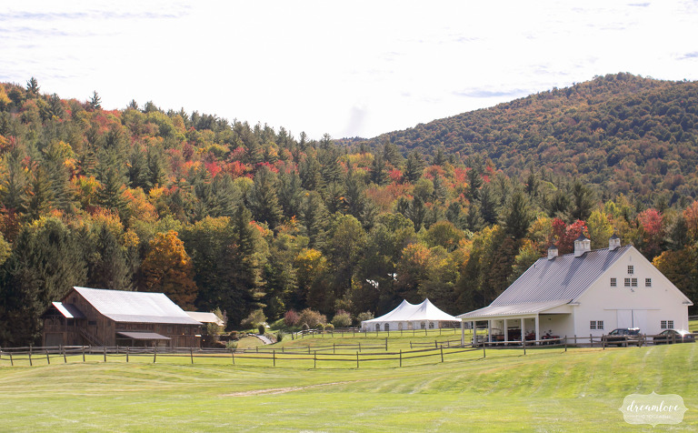 Wedding barns sit in a field at luxury Vermont venue.