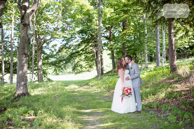 Bride and groom kiss after their ceremony at the Sugarbush Resort in VT.